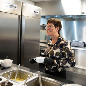 Canteen employee serving lunch